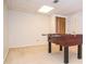 Spacious game room featuring a foosball table, bright lighting, and ample space for entertaining at 830 Montego Sw Way, Lilburn, GA 30047