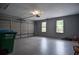 Clean, freshly-painted garage with automatic door and two bright windows at 830 Montego Sw Way, Lilburn, GA 30047