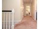 Upstairs hallway featuring carpet and doors at 830 Montego Sw Way, Lilburn, GA 30047