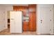 Kitchen with ample wood cabinets, white refrigerator, and neutral tile floor at 830 Montego Sw Way, Lilburn, GA 30047