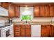 Well-lit kitchen boasts granite countertops, wooden cabinets, and modern appliances at 830 Montego Sw Way, Lilburn, GA 30047