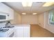 Cozy kitchenette with modern appliances and tile flooring, complemented by natural light from the window at 830 Montego Sw Way, Lilburn, GA 30047