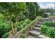 Picturesque landscaping features lush plants and stone steps leading to the house at 830 Montego Sw Way, Lilburn, GA 30047