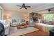 Bright living room with hardwood floors, a brick fireplace, built-in bookshelves, and neutral-toned furniture at 830 Montego Sw Way, Lilburn, GA 30047