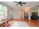Bright living room with hardwood floors, ceiling fan, and ample natural light at 830 Montego Sw Way, Lilburn, GA 30047