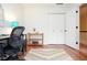 Bright office featuring hardwood floors, black desk and chair, closet and small bookshelf at 830 Montego Sw Way, Lilburn, GA 30047