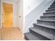 Staircase with carpet treads, and hallway to another room featuring tile flooring at 830 Montego Sw Way, Lilburn, GA 30047