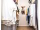 Walk-in closet with clothes on hangers and shelves at 830 Montego Sw Way, Lilburn, GA 30047