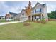 Two story house with welcoming porch and landscaped yard at 537 Daffodil Ln, Mcdonough, GA 30253