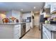 Modern kitchen with white cabinets, granite countertops, and stainless steel appliances at 537 Daffodil Ln, Mcdonough, GA 30253