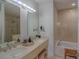 Bright bathroom with double sinks, soaking tub, and glass shower at 250 Park Avenue West Nw # 903, Atlanta, GA 30313