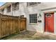 Brick townhouse with red door and a wood fence at 771 Jordan Ln # F, Decatur, GA 30033