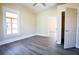 Bright bedroom with wood-look floors, ceiling fan, and ample closet space at 3 Bay St, Covington, GA 30014