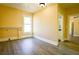 Bedroom with wood-look floors, neutral walls, and an adjacent bathroom at 3 Bay St, Covington, GA 30014