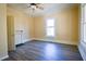 Well-lit bedroom with wood-look floors and a fireplace at 3 Bay St, Covington, GA 30014