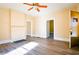 Sunlit living room with hardwood floors, ceiling fan, and access to exterior at 3 Bay St, Covington, GA 30014