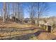 Landscaped backyard with mature trees and a wooded backdrop at 610 Lovinggood Trl, Woodstock, GA 30189