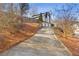 Long driveway leading to a three-car garage at 610 Lovinggood Trl, Woodstock, GA 30189