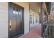 Black front door with sidelights and a welcoming porch at 610 Lovinggood Trl, Woodstock, GA 30189