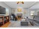 Cozy living room features a fireplace, hardwood floors, and comfortable seating at 610 Lovinggood Trl, Woodstock, GA 30189