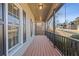 Covered porch with wooden flooring and black railing at 610 Lovinggood Trl, Woodstock, GA 30189