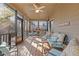 Relaxing screened porch with seating area and ceiling fan at 610 Lovinggood Trl, Woodstock, GA 30189