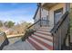 Steps up to the front porch with a black railing at 610 Lovinggood Trl, Woodstock, GA 30189