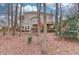 Rear view of home with a deck and wooded backyard at 1095 Whitehawk Trl, Lawrenceville, GA 30043