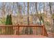 Deck view with a wooden railing, offering a scenic overlook of a wooded backyard at 1095 Whitehawk Trl, Lawrenceville, GA 30043