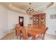 Formal dining room with elegant chandelier, wainscoting, and a built-in china cabinet for sophisticated entertaining at 1095 Whitehawk Trl, Lawrenceville, GA 30043