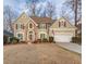 Charming two-story home featuring stone accents, red shutters, a two car garage and well-maintained landscaping at 1095 Whitehawk Trl, Lawrenceville, GA 30043