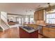 Open kitchen featuring hardwood floors, island cooktop, light-colored cabinets, and stainless steel appliances at 1095 Whitehawk Trl, Lawrenceville, GA 30043