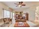 Bright living room with hardwood floors, ceiling fan, and open layout leading to the kitchen, great for entertaining at 1095 Whitehawk Trl, Lawrenceville, GA 30043