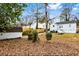 Large backyard with wooden fence, mature trees and a storage shed at 1380 Westmont Sw Rd, Atlanta, GA 30311