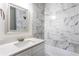 Bathroom featuring white marble tiling, vanity and mirror at 1380 Westmont Sw Rd, Atlanta, GA 30311