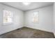 Bright bedroom features carpet and two windows allowing lots of natural light at 1380 Westmont Sw Rd, Atlanta, GA 30311