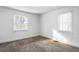 Bedroom with two windows letting in natural light and neutral carpeting at 1380 Westmont Sw Rd, Atlanta, GA 30311