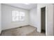 Bedroom features neutral carpet, a window, and a closet with white doors at 1380 Westmont Sw Rd, Atlanta, GA 30311