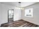 Dining room featuring hardwood floors, modern light fixture, and neutral paint at 1380 Westmont Sw Rd, Atlanta, GA 30311