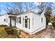 A stone walkway leading to a home with white siding, black trim and a dark shingled roof at 1380 Westmont Sw Rd, Atlanta, GA 30311