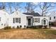 Charming bungalow featuring white siding, black shutters, and a cozy front entrance at 1380 Westmont Sw Rd, Atlanta, GA 30311