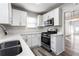 Modern kitchen with stainless steel appliances, white cabinetry, and white countertops at 1380 Westmont Sw Rd, Atlanta, GA 30311