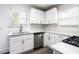 A modern kitchen with white cabinets, stainless steel appliances and a stainless steel sink at 1380 Westmont Sw Rd, Atlanta, GA 30311