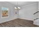 Dining room with hardwood floors, chandelier and stairs to upper level at 4131 Fulson Dr, Lilburn, GA 30047