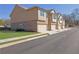 Side view of townhomes showcasing attached garages and brick accents at 4131 Fulson Dr, Lilburn, GA 30047