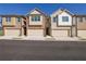 View of townhomes with attached garages and neutral color palettes at 4131 Fulson Dr, Lilburn, GA 30047