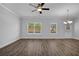 Bright living room with hardwood floors, large windows, and ceiling fan at 4131 Fulson Dr, Lilburn, GA 30047