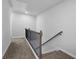 Upstairs hallway with carpeted floors and an elegant railing at 4131 Fulson Dr, Lilburn, GA 30047