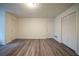 Bedroom featuring wood-look flooring, large closet, and several outlets at 1119 Summer Brook Rd, Atlanta, GA 30349