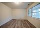 Bright bedroom with wood-look floors, neutral walls, and a window view at 1119 Summer Brook Rd, Atlanta, GA 30349
